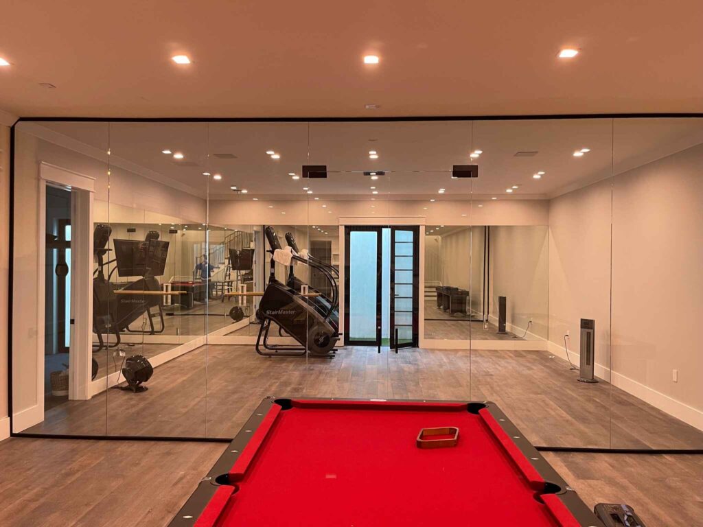 Glass wall separating a gym from an outdoor billiard pool, showcasing gym glass wall by Glass Elements