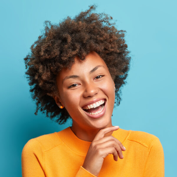 Portrait of a glad young Afro-American woman, a satisfied customer of Glass Elements