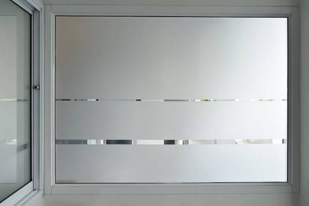 istockphoto-1413682039-612×612 Aluminum sliding window of office, office sliding glass window, Decorative Glass Film on door of office, Closeup Frosted Glass Thick Film for reduced visibility across.